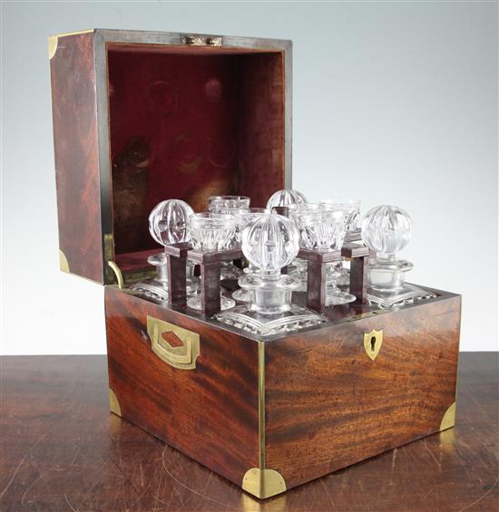 A George III mahogany and brass bound travelling decanter set, 10in.